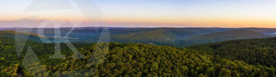 Aerial shot of rolling hills and forest